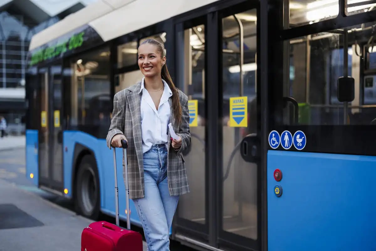 Girl walking by bus